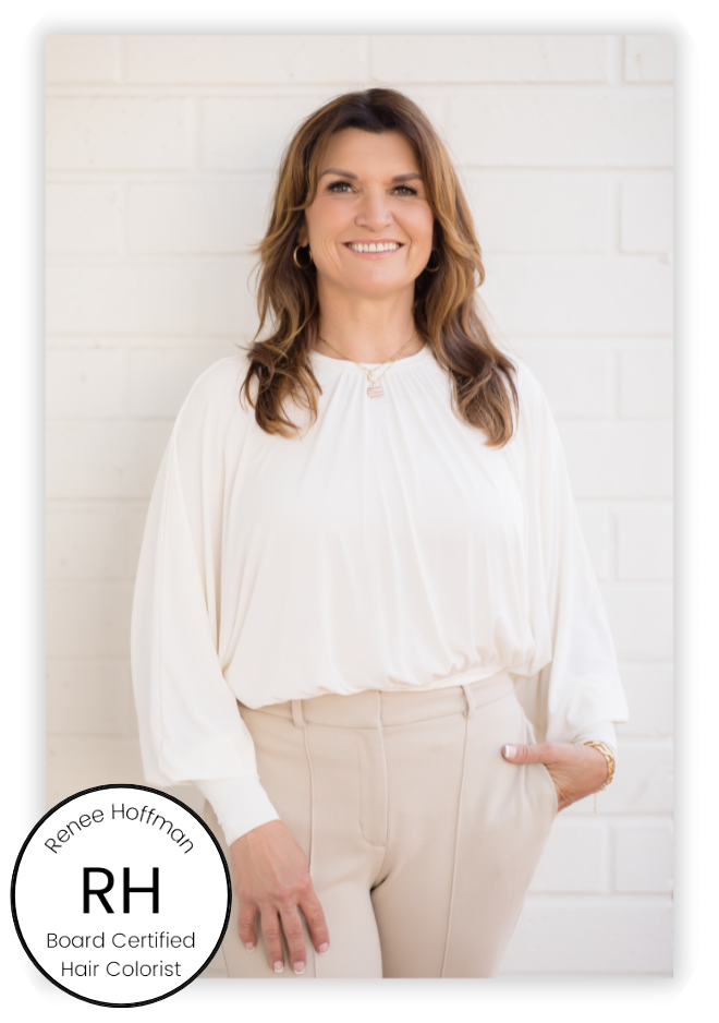 A woman named Renee Hoffman,  with long brown hair, wearing a white blouse and beige pants, stands smiling against a white brick wall. A circular badge in the corner reads, "Renee Hoffman Beauty, RH, Board Certified Hair Colorist," spotlighting her expert color analysis and personal styling services.
